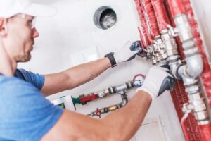 plumber working with piping to start a plumbing business