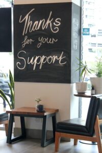 thanks for your support written on chalkboard at coffee shop to show customer appreciation