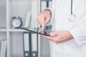 doctor holding and using tablet containing information protected by the privacy rule HIPAA